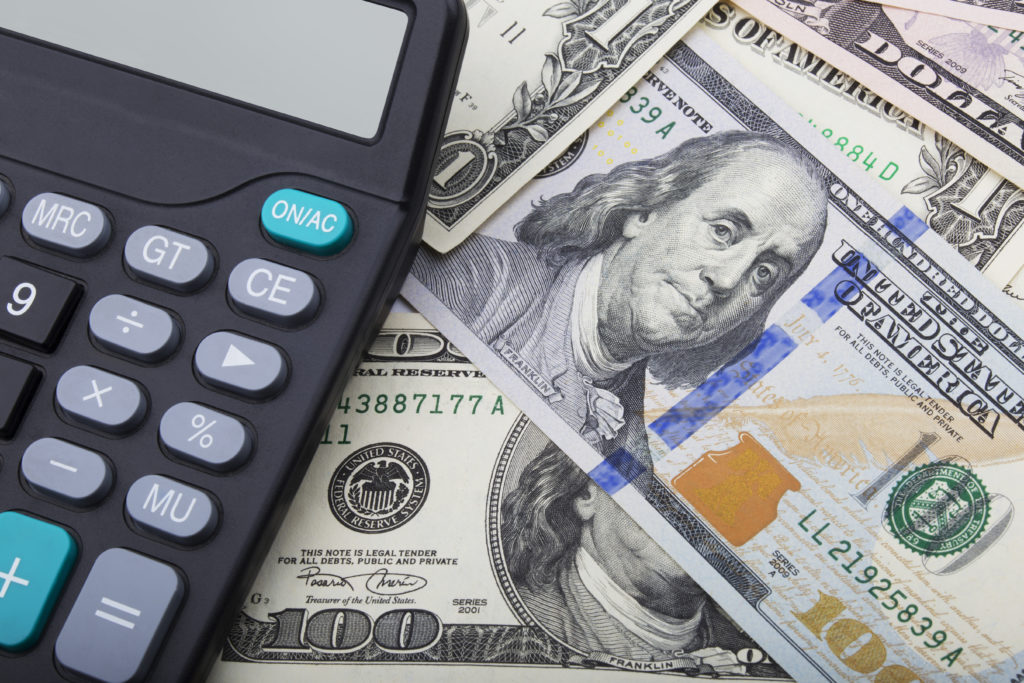 Calculator and $100 dollar bills